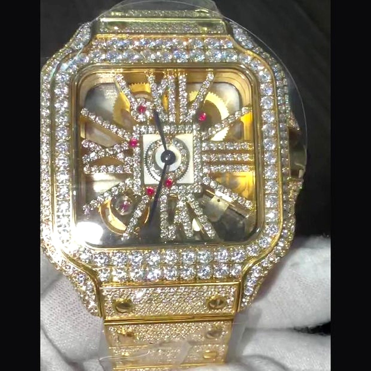 Skeleton dial showing the movement, gold case